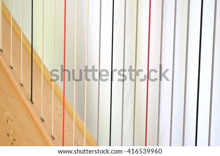 Closeup of the strings on a concert grand, pedal harp. Royalty-Free Stock Photo #416539960