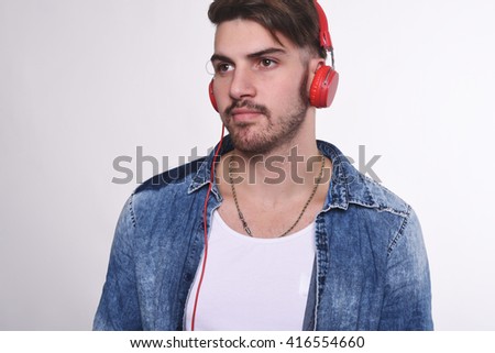 Portrait of young handsome man listening to music. Isolated white background.