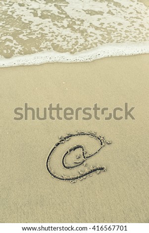 Email symbol draw on beach