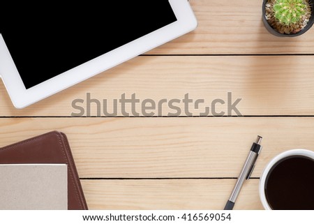 Office desk table with blank screen tablet, coffee cup ,pen and leather notebook.Top view with copy space.Office desk table concept.Office supplies and gadgets on desk table.Flat lay images.