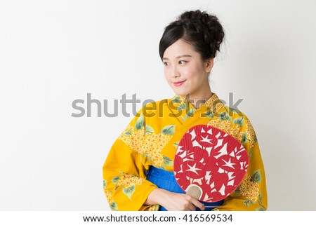 attractive asian woman wearing traditional Japanese casual summer kimono called "Yukata".
