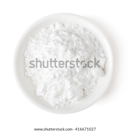 Bowl of powder sugar isolated on white background, top view Royalty-Free Stock Photo #416671027