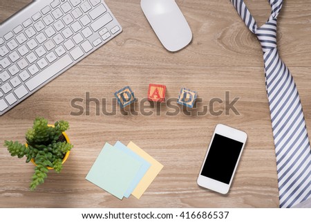 Fathers day composition. Top view of office table with keyboard, note, pen and coffee with copy space on wooden desk background