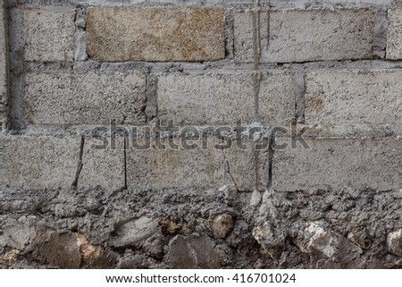 raw cement brick wall with foundation Royalty-Free Stock Photo #416701024