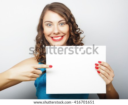 Smiling young casual style woman showing blank signboard