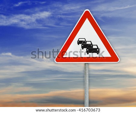 Triangle road sign automobile on rod with cloudy sky