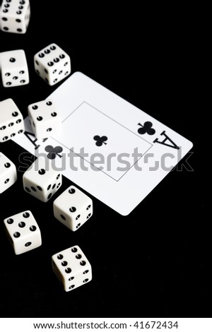 Die and playing card in black background. Game object