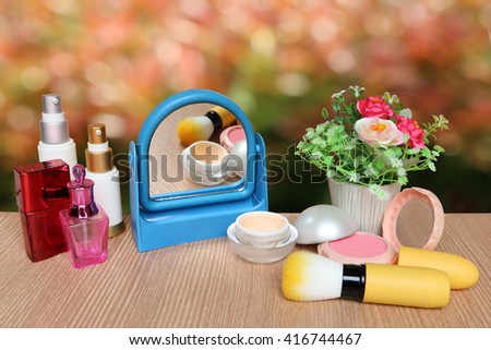 mirror and cosmetic tool with bokeh from bush background