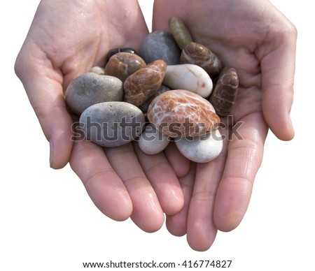 Female hands showing different colors pebbles isolated on white background