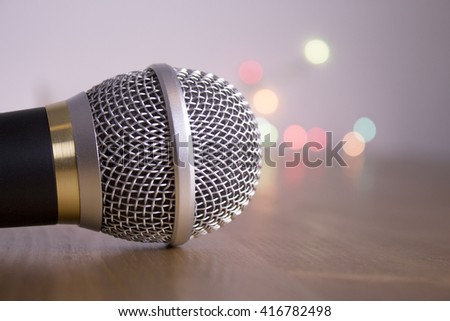 Top of a microphone on gray background with bright colors