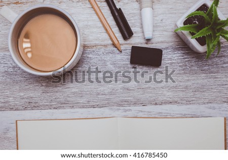Brownie cheese cake,pen,pencil and coffee on wooden background