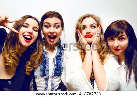 Four pretty funny girls making selfie at crazy party, funny grimaces and fun, black and white clothes, celebrating, making selfie, image with flash, toned colors.