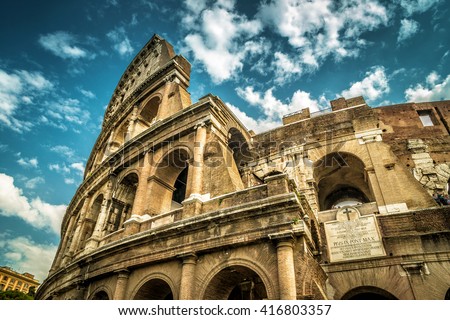 Coliseum or Colosseum in Rome, Italy, Europe. Ancient stadium, Colisseum is World landmark. View of Coliseum top on sky background. Scenery of old Coliseum, monument of Roman Empire. Travel theme. Royalty-Free Stock Photo #416803357