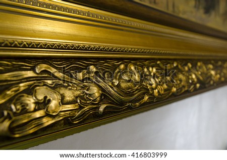 Golden picture frame with 3D pattern. Closeup view background