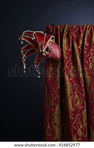  Old Venetian masks with bell on dark background