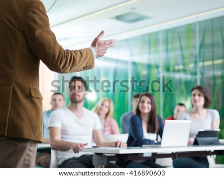 close up of teacher hand with marker while teaching lessons in school  classroom to students Royalty-Free Stock Photo #416890603