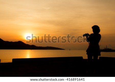 silhouette of woman using the digital camera take photho when sunrise-2