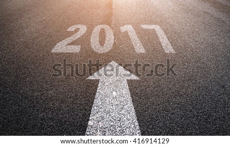 Driving on an empty asphalt road through the agricultural field. Business concept for the new year 2017.