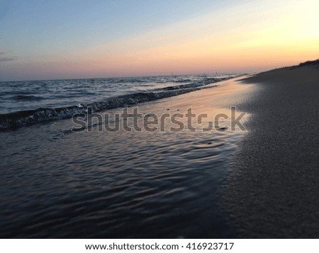 Beautiful sunset on a beach by Lake Erie Royalty-Free Stock Photo #416923717