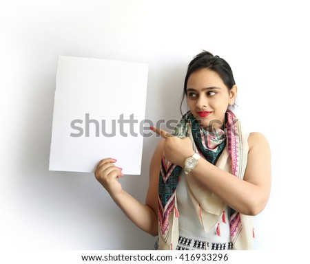 Beautiful indian woman pointing her finger with holding a blank signboard, isolated on white background