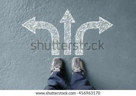Taking decisions for the future man standing with three direction arrow choices, left, right or move forward Royalty-Free Stock Photo #416963170