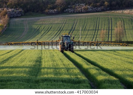 Agriculture - A farmer spraying fertilizer on his crops - North Yorkshire - England. Royalty-Free Stock Photo #417003034