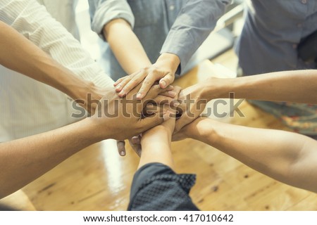 business people showing unity with their hands together, soft focus, vintage tone Royalty-Free Stock Photo #417010642