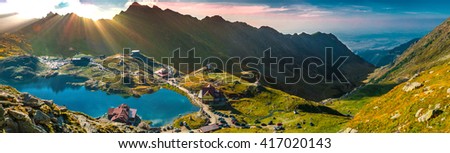 God rays over the mountains. Transfagarasan Balea glacier lake, panoramic view - Lake, is a glacier lake situated at 2.034 m. of altitude in the Mountains, in central Romania, Sibiu County.