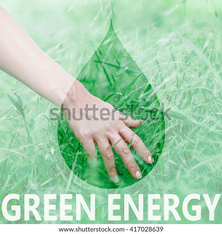 Woman's hand touching the grass, connecting with nature