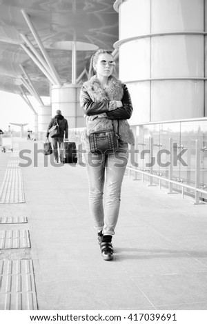 Black and white photography of beautiful young lady walking, copy space background