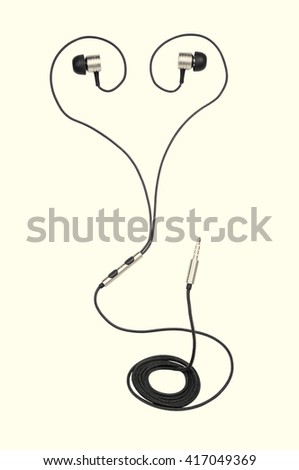 headphones stacked in heart shape on isolated toned background executed in macro style