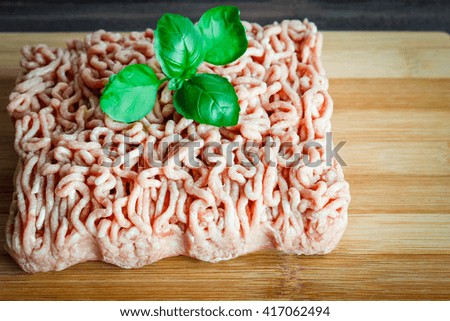 minced meat on a wooden background.