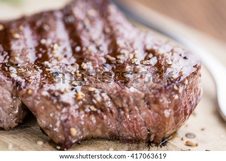Piece of Grilled Beef as detailed close-up shot (selective focus) on vintage background
