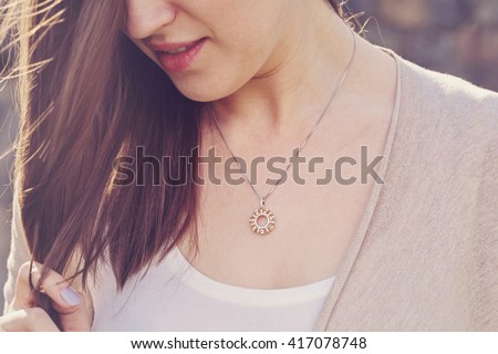 Detal of woman wearing a luxury pendant Royalty-Free Stock Photo #417078748