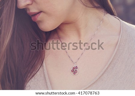 Detal of woman wearing a luxury pendant Royalty-Free Stock Photo #417078763