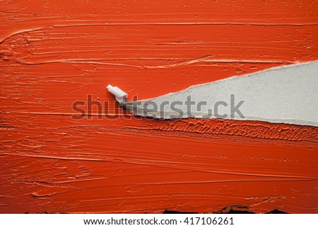 Torn pieces of paper on red oil paint background