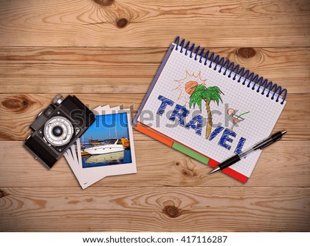Camera, photo and notepad with drawing beach holiday concept. Work desk tourist.