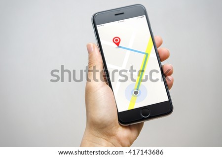 Woman hand holding mobilephone with program of navigation. The navigation software is on your phone. Royalty-Free Stock Photo #417143686