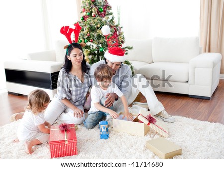 happy family opening Christmas presents at home