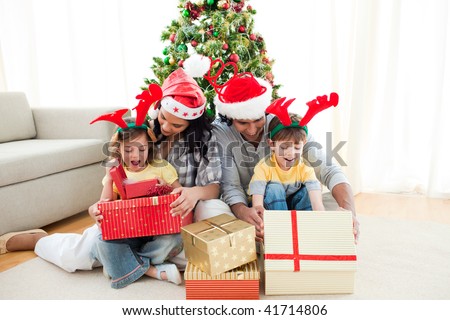 happy family opening Christmas presents at home