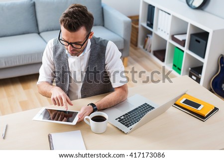 self employment - man working with digital tablet from home Royalty-Free Stock Photo #417173086