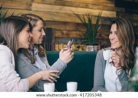 Three young woman taking selfie
