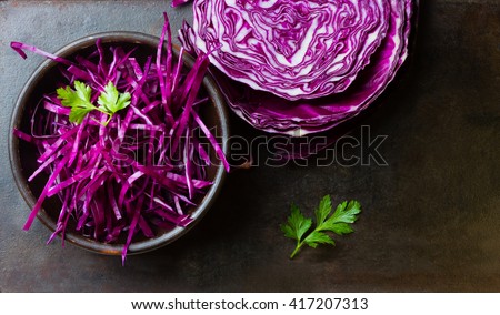Shredded red cabbage in clay bowl on black background. Vegetarian healthy food. Top view Royalty-Free Stock Photo #417207313