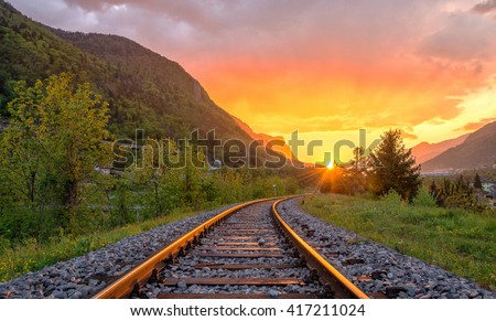 Railroad tracks in the setting sun Royalty-Free Stock Photo #417211024