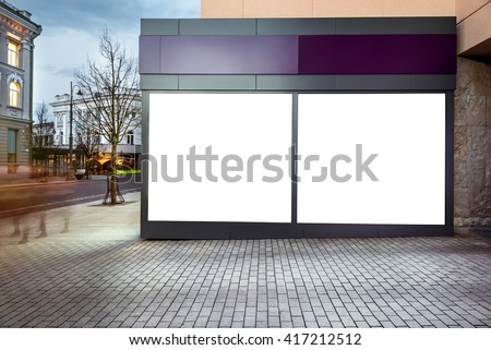 Mock up of blank white modern showcase in a city at night. Front view