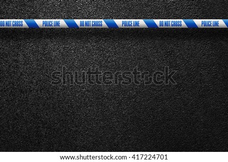 English white-blue police line in the background smooth asphalt road. Do not cross. The texture of the tarmac, top view.