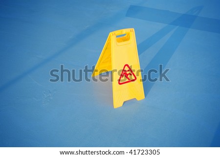 close up shot of a yellow caution on floor