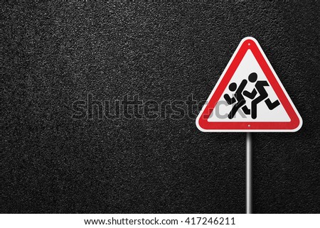Road sign triangular shape with a picture of a children on a background of asphalt. The texture of the tarmac, top view.