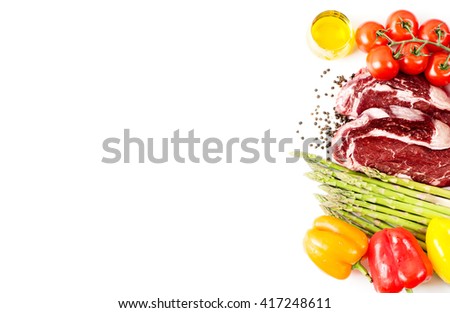 Raw steak with vegetables and spices isolated on white with copy space