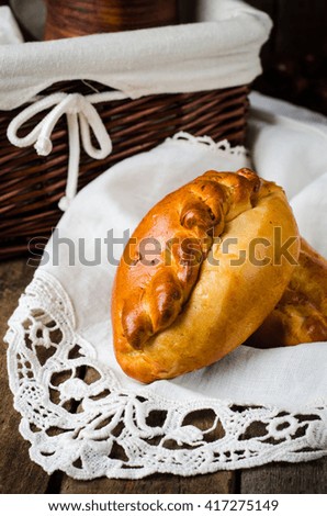 Pies stuffed meat on wooden background, ukrainian or russian cuisine. Selective focus.